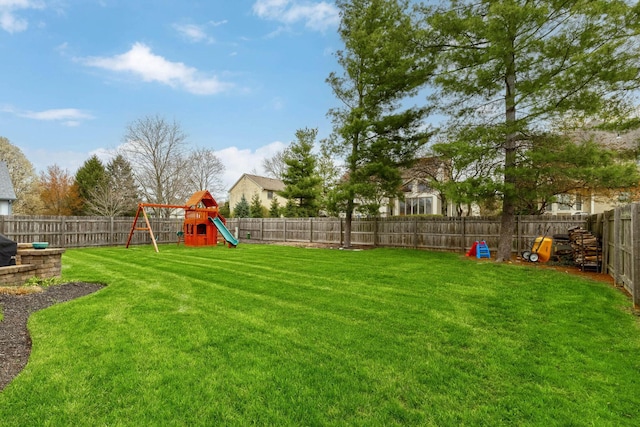 view of yard featuring a fenced backyard and a playground