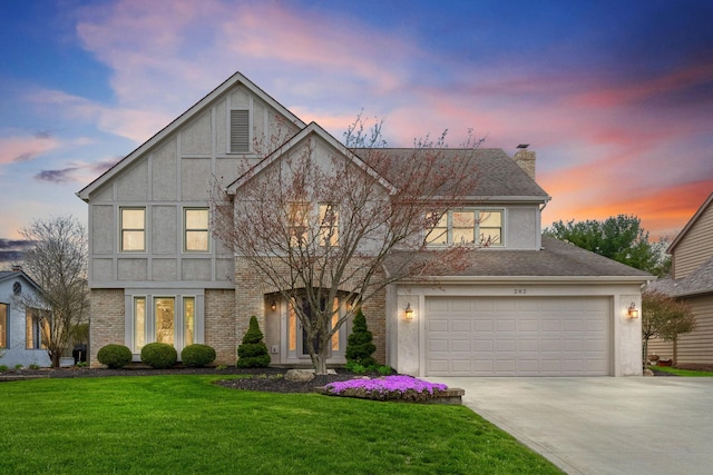 view of front of home with a chimney, stucco siding, concrete driveway, a lawn, and a garage