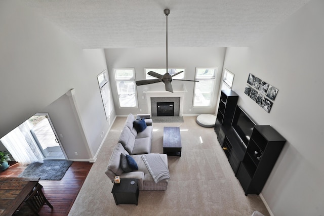 6185 Pollard Place Dr, Hilliard, OH 43026 - living room with a fireplace, a textured ceiling, baseboards, and ceiling fan
