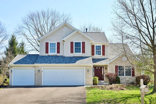6185 Pollard Place Dr, Hilliard, OH 43026 - view of front of home with stucco siding, stone siding, aphalt driveway, a garage, and a shingled roof