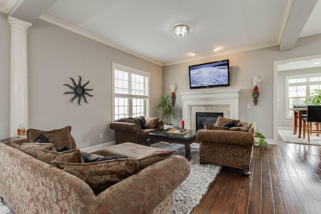 living room with dark wood-style flooring, baseboards, crown molding, and a fireplace