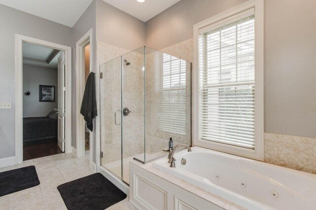 ensuite bathroom with a shower stall, tile patterned floors, ensuite bathroom, and a tub with jets