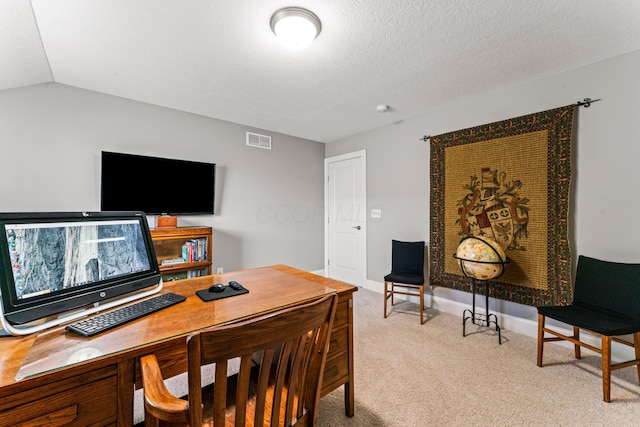 carpeted office space featuring visible vents, baseboards, lofted ceiling, and a textured ceiling