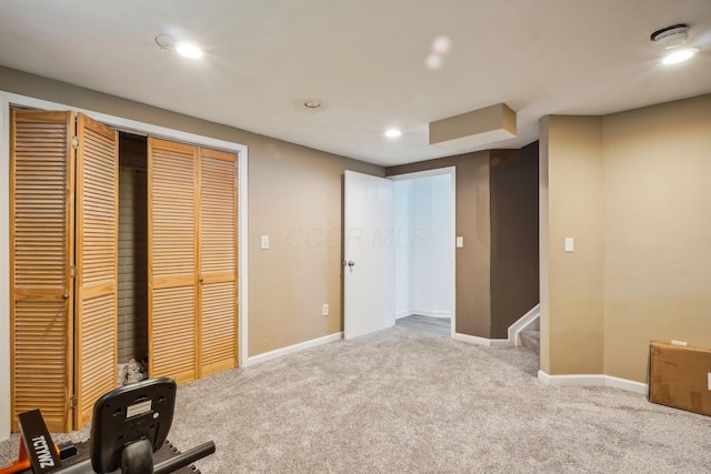 interior space with a closet, baseboards, carpet, and recessed lighting