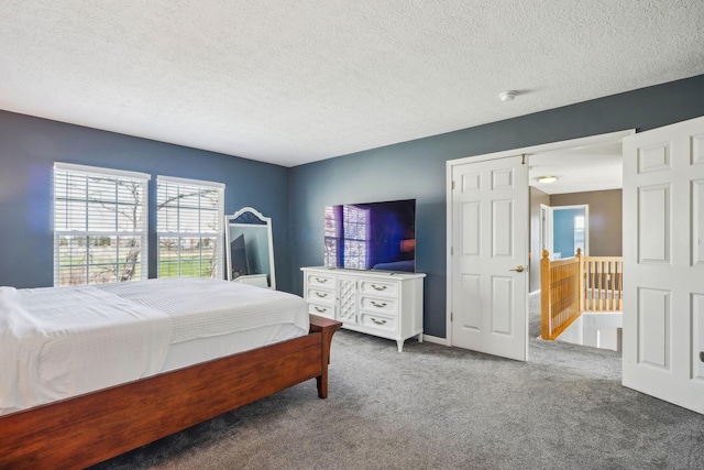 bedroom featuring carpet and a textured ceiling