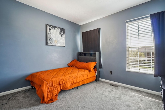 bedroom with carpet flooring, baseboards, and visible vents