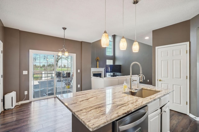 kitchen featuring light stone countertops, dark wood-type flooring, dishwasher, a sink, and baseboards