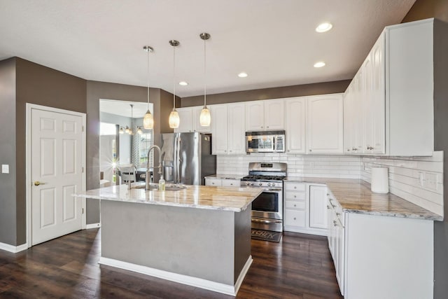 kitchen with a sink, light stone countertops, dark wood-type flooring, and stainless steel appliances