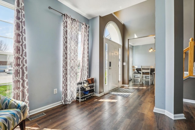 entrance foyer featuring visible vents, baseboards, and wood finished floors