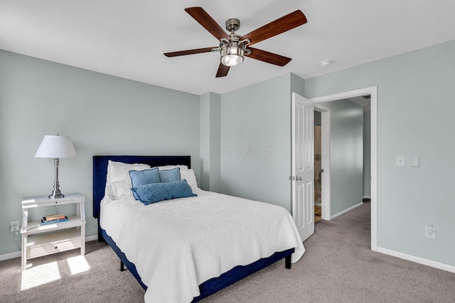 carpeted bedroom featuring baseboards and a ceiling fan