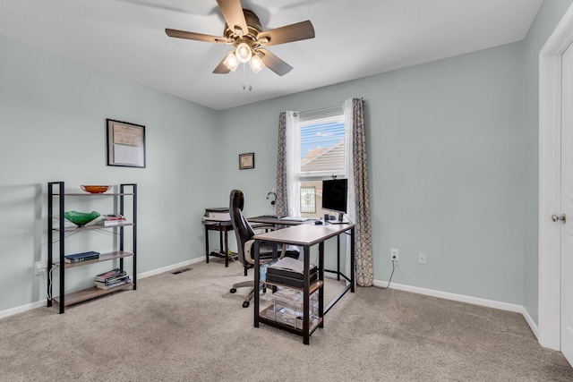 office space with carpet floors, baseboards, and ceiling fan