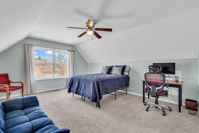 carpeted bedroom featuring ceiling fan, a textured ceiling, visible vents, lofted ceiling, and baseboards