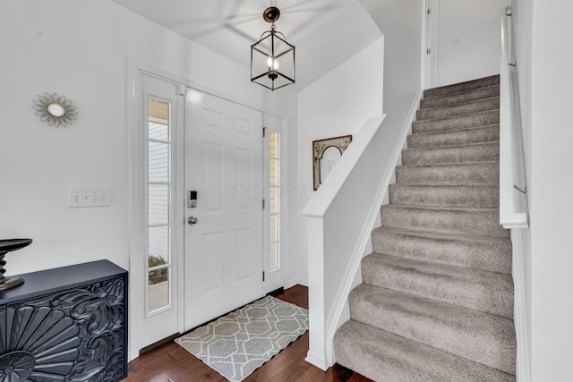 foyer with stairway and dark wood-style flooring