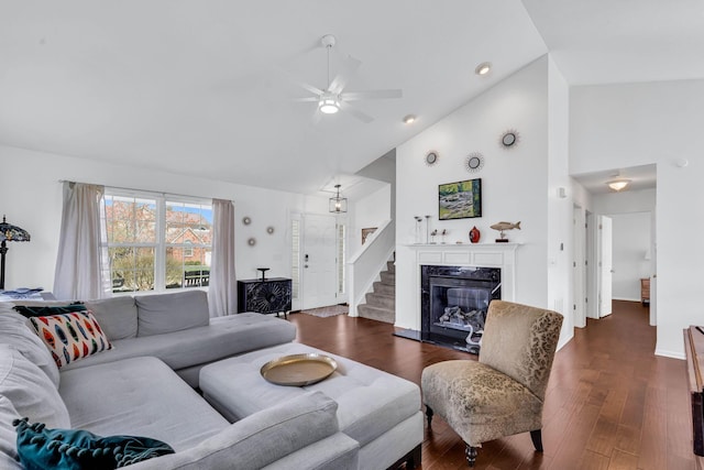 living room with high vaulted ceiling, a fireplace, dark wood-type flooring, and ceiling fan