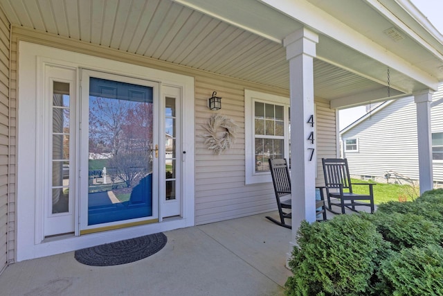 doorway to property with visible vents and covered porch