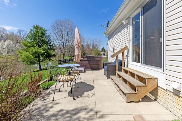 view of patio / terrace with a hot tub