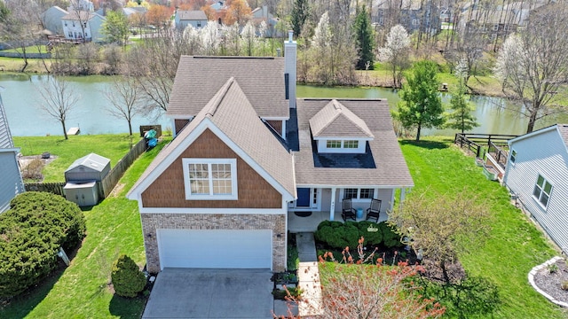birds eye view of property with a water view