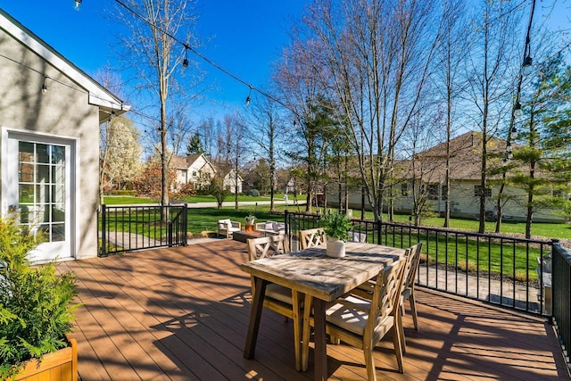 deck with a yard and outdoor dining area