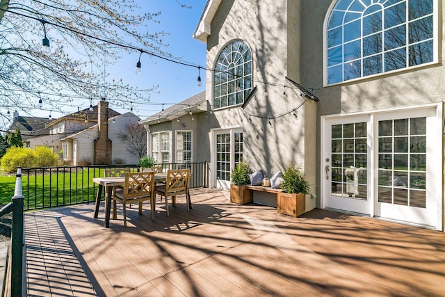 wooden deck featuring a residential view and outdoor dining area