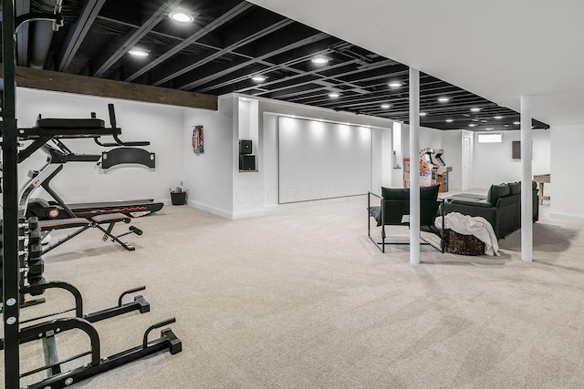 workout area with baseboards and carpet flooring