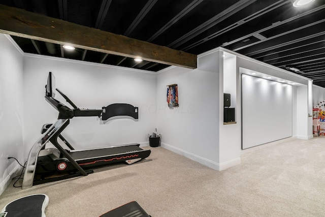 workout room featuring baseboards and carpet floors