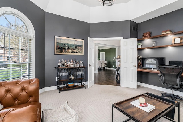 interior space featuring visible vents, baseboards, and plenty of natural light