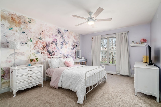 bedroom featuring light carpet, baseboards, and a ceiling fan