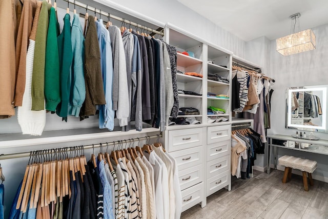 walk in closet with light wood finished floors