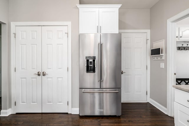 kitchen featuring white cabinetry, high end refrigerator, baseboards, and dark wood finished floors