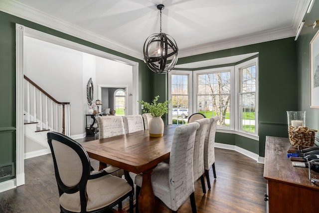 dining area featuring crown molding, a wealth of natural light, dark wood-type flooring, and stairs