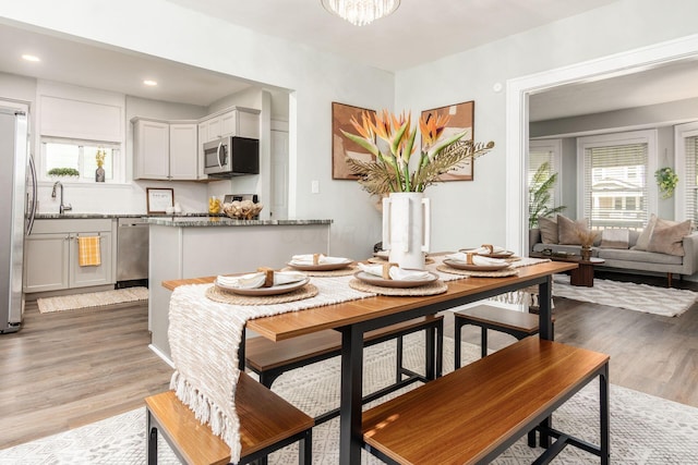 1069 Miller Ave, Columbus, OH 43206 - dining area with healthy amount of natural light, light wood-style flooring, recessed lighting, and a chandelier