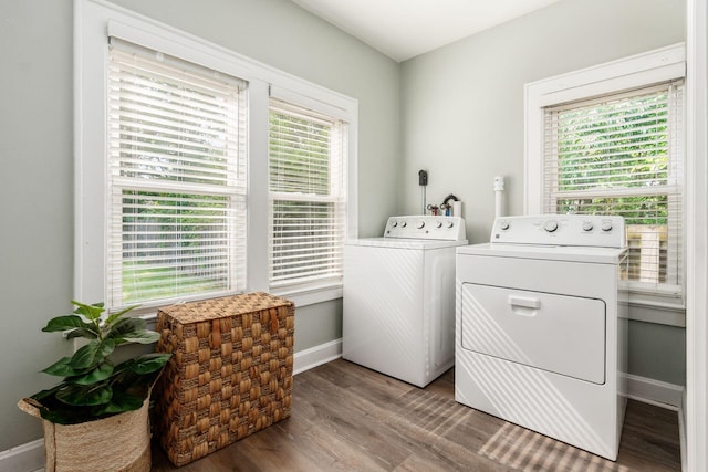 1069 Miller Ave, Columbus, OH 43206 - washroom featuring washing machine and clothes dryer, baseboards, and wood finished floors