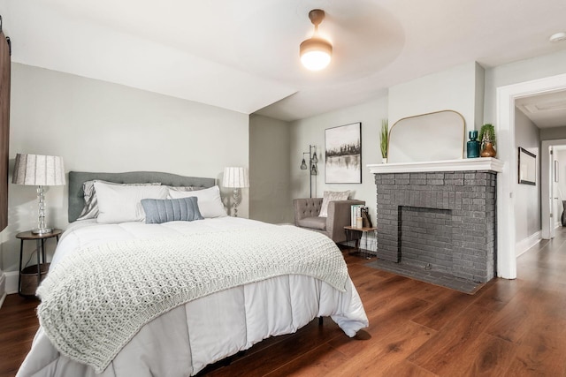 1069 Miller Ave, Columbus, OH 43206 - bedroom featuring wood finished floors, baseboards, ceiling fan, and a brick fireplace