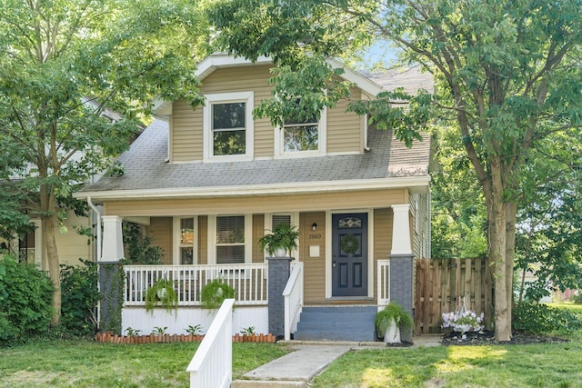 1069 Miller Ave, Columbus, OH 43206 - view of front of property with covered porch, a front yard, and roof with shingles