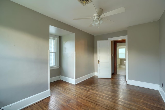 spare room featuring baseboards, a ceiling fan, hardwood / wood-style flooring, and visible vents