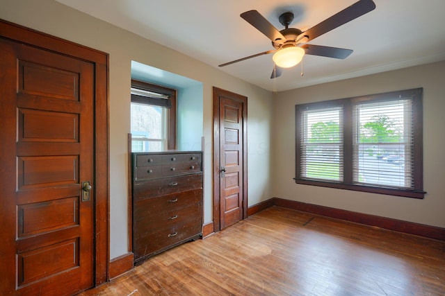 unfurnished bedroom with baseboards, ceiling fan, and light wood finished floors