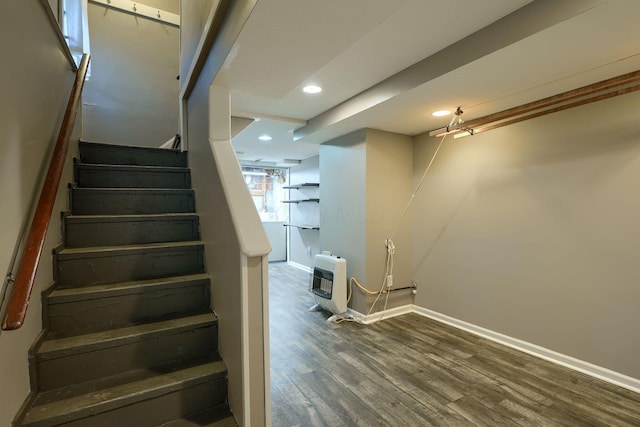 stairway with recessed lighting, baseboards, heating unit, and wood finished floors