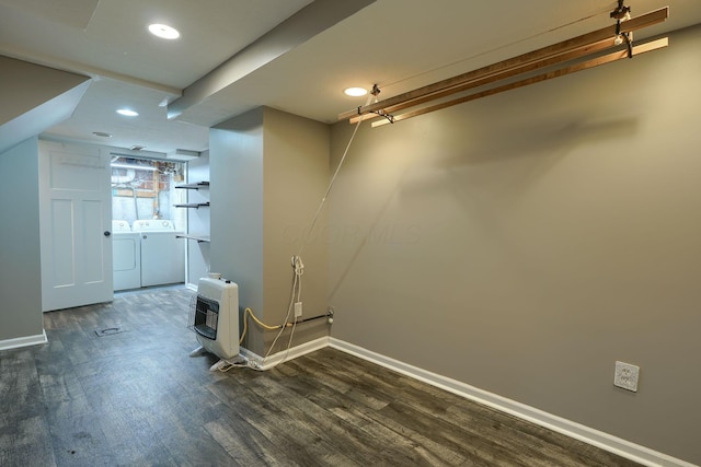 basement with heating unit, dark wood-style flooring, washing machine and dryer, baseboards, and recessed lighting