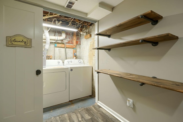 clothes washing area with separate washer and dryer, laundry area, and visible vents