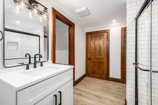 1065-1067 Franklin Ave, Columbus, OH 43205 - full bath featuring vanity, wood finished floors, a stall shower, baseboards, and recessed lighting