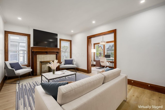 1065-1067 Franklin Ave, Columbus, OH 43205 - living room with baseboards, a tiled fireplace, light wood finished floors, and recessed lighting