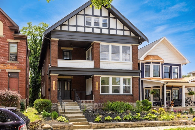 1065-1067 Franklin Ave, Columbus, OH 43205 - view of front of home with covered porch, brick siding, and a balcony