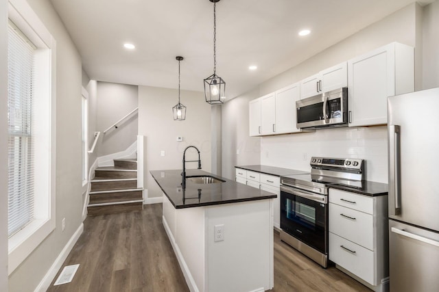 776 S 22nd St Unit 774, Columbus, OH 43206 - kitchen with a sink, dark countertops, dark wood finished floors, stainless steel appliances, and decorative backsplash