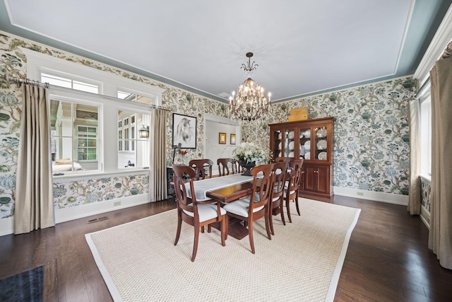 dining room with a chandelier, baseboards, and wallpapered walls