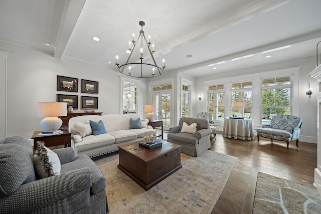 living area with ornamental molding, recessed lighting, a notable chandelier, and hardwood / wood-style flooring
