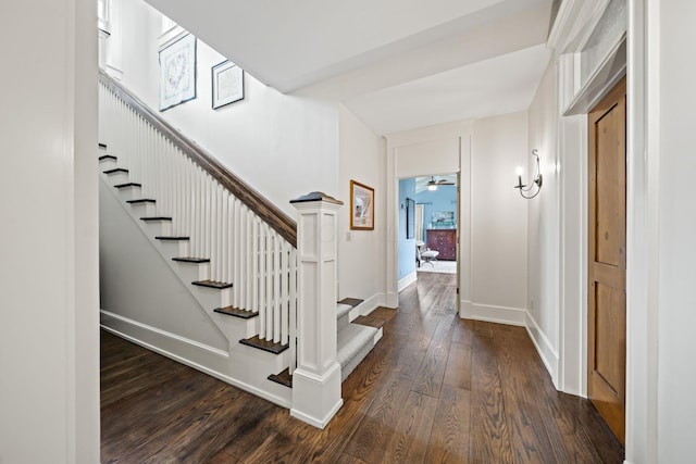 stairway featuring wood finished floors and baseboards