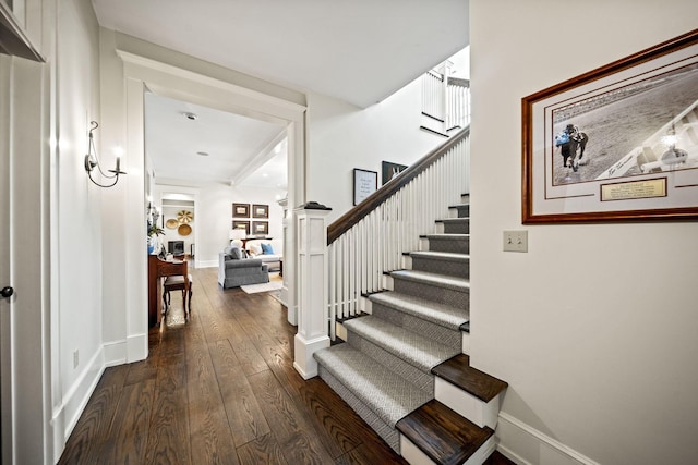 staircase featuring wood-type flooring and baseboards