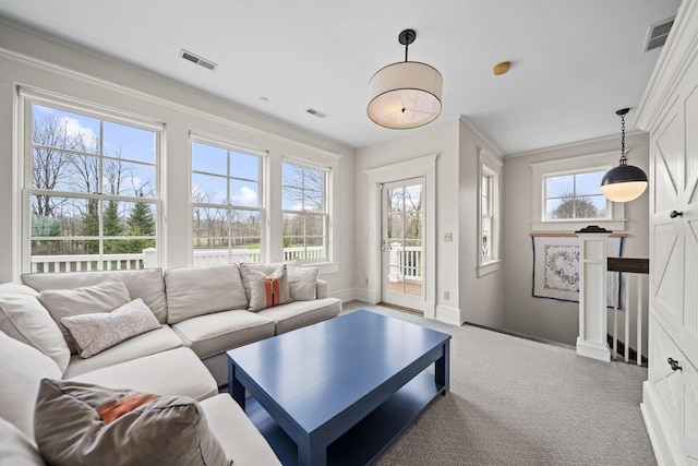 carpeted living room featuring visible vents and baseboards
