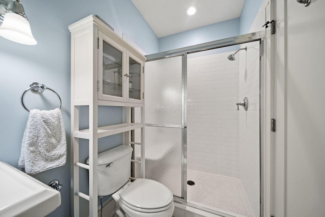full bath featuring a shower stall and toilet