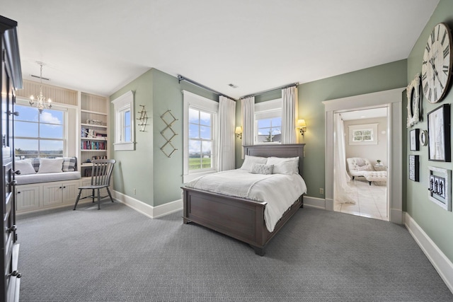carpeted bedroom featuring a chandelier, visible vents, and baseboards
